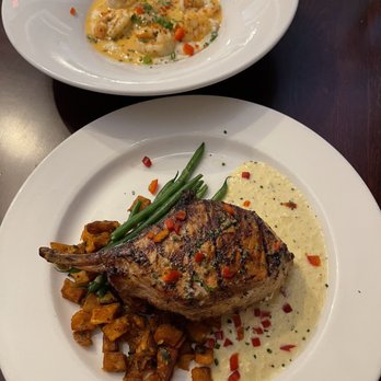 Muriel's Jackson Square - Wood Grilled Pork Chop (bottom) & Shrimp & Grits (top) - Cajun/Creole Near Me - New Orleans, Louisiana Muriel's Jackson Square - Wood Grilled Pork Chop (bottom) & Shrimp & Grits (top) - Cajun/Creole Near Me - New Orleans, Louisiana