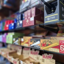 VapeX Smoke Shop - Shelf of raw cones and rolling papers inside smoke shop in Rogers