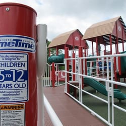 Egypt Park - Ramped, accessible barn themed playground structure incorporates pigs, roosters, tractors in honor of Lollypop Farm.