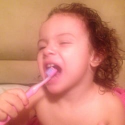 Pueblo De Ninos Dental - A patient at home brushing