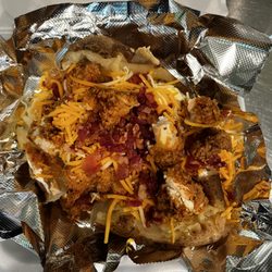 Let’s Eat Caribbean & Southern Cuisine - Loaded baked potato with sour cream, butter, bacon bits & chicken tender