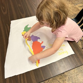 Olympic View Montessori - Gluing a map piece on South America. - Montessori Schools Near Me - Edmonds, Washington Olympic View Montessori - Gluing a map piece on South America. - Montessori Schools Near Me - Edmonds, Washington