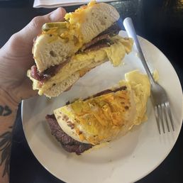 pastrami egg sando on a jalapeño cheese bagel