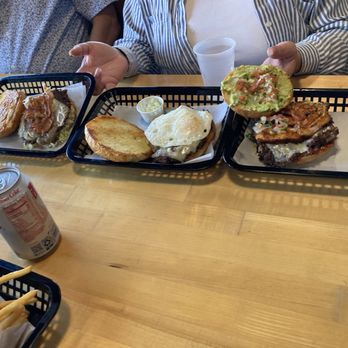 Burgers vs Tacos - Burger on the right lucha liner burger in the middle su no burger and at the left gladiator burger - Burgers Near Me - San Antonio, Texas