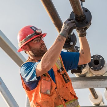 A.O. Reed & Co. - a construction worker holding a pipe - Plumbing Near Me - San Diego, California A.O. Reed & Co. - a construction worker holding a pipe - Plumbing Near Me - San Diego, California
