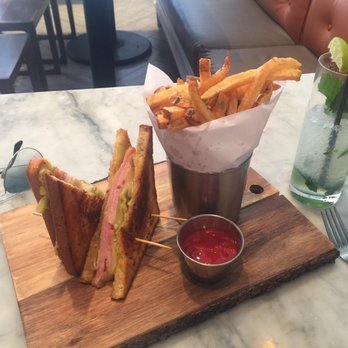 Orange Blossom - Cuban Sandwich in white bread?? IMO should be served on Cuban bread and way too greasy.  Fries looked good but were not crispy. - Breakfast & Brunch Near Me - Miami Beach, Florida