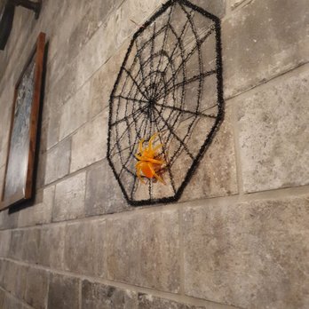 University Roadhouse - a spider web hanging on a brick wall - American Near Me - Kalamazoo, Michigan