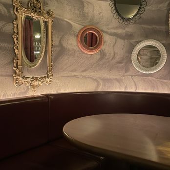 Bar Prima - a corner booth with mirrors on the wall - Italian Near Me - Toronto, Ontario