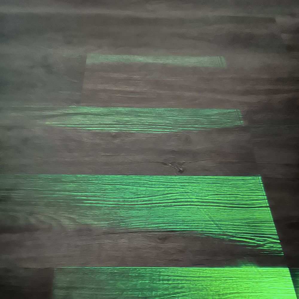 Shining a light across the planks shows curling