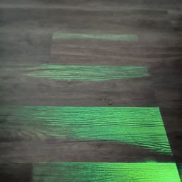 Shining a light across the planks shows curling