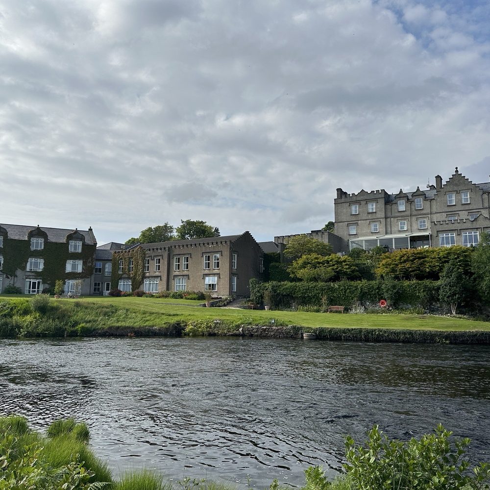 Ballynahinch Castle Hotel - View of resort from across River - Hotels Near Me