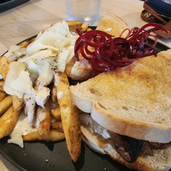 Forte Resto Lounge - Braised Beef sandwich with caramelized onions on sourdough. Generous side of delicious, crisp truffle fries.