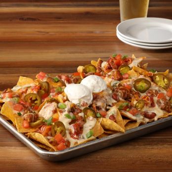 Hickory Tavern - a tray of nachos and a glass of beer - American Near Me - Hickory, North Carolina Hickory Tavern - a tray of nachos and a glass of beer - American Near Me - Hickory, North Carolina