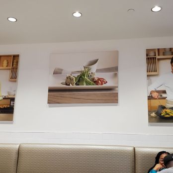 Cat Cora's Kitchen - a woman sitting on a couch - New American Near Me - Atlanta, Georgia Cat Cora's Kitchen - a woman sitting on a couch - New American Near Me - Atlanta, Georgia
