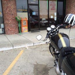 a motorcycle parked in front of a restaurant a motorcycle parked in front of a restaurant