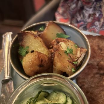 Das Dorf - Potatoes and cucumber salad, served with the wienerschnitzel - German Near Me - Hamburg, HH