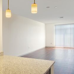 Charlesbank Apartment Homes - Large living room that opens to a private balcony