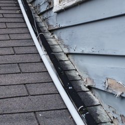 Akin's Precision Home Inspection - Wood siding finished too close to roof material. Should be A minimum of 1 inch clearance to roof material