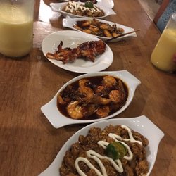 NatTribu - From bottom: tuna sisig, sweet and spicy shrimp, squid, garlic shrimp, more tuna sisig, and pork belly. Large mango shakes.