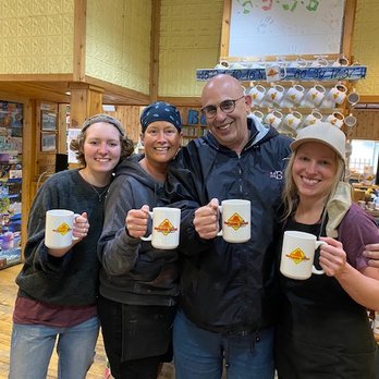Falling Rock Cafe and Book Store - Me with the 3 ladies who work here, all of us holding a Falling Rock cup - Bookstores Near Me - Munising, Michigan
