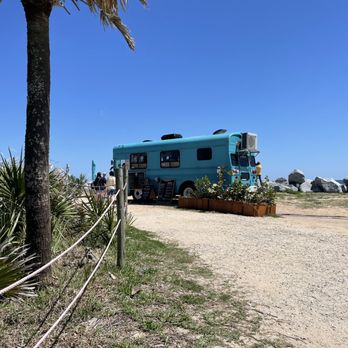 Ragga Bean Coffee - a blue bus parked on a dirt road - Food Trucks Near Me - Saint Augustine , Florida