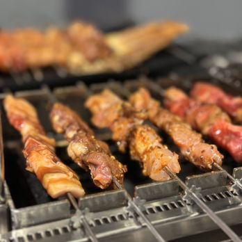 Honolulu Skewer House - a variety of meats being cooked on a grill - Chinese Near Me - Honolulu, Hawaii