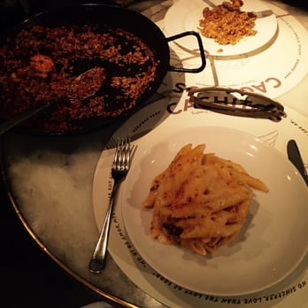 Cachitos - Seafood paella on the left with 4 prawns and sausage pieces (!!). Macaroni with parmegiani and iberian meat at the bottom. - Tapas Bars Near Me - Barcelona, B