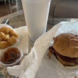 Burger with bbq sauce, bacon, fried onions, pickles, tater tots, iced tea. Burger with bbq sauce, bacon, fried onions, pickles, tater tots, iced tea.