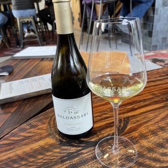 Baldassari Wine Lounge - a glass of wine and a bottle of wine - Wine Tasting Room Near Me - Windsor, California Baldassari Wine Lounge - a glass of wine and a bottle of wine - Wine Tasting Room Near Me - Windsor, California