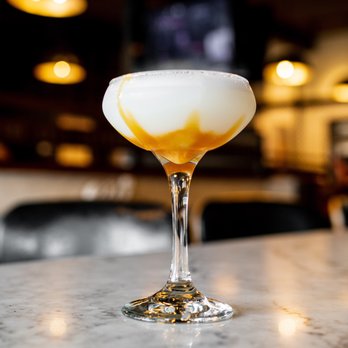 Bettola - a glass of liquid sitting on a table - Pizza Near Me - Cranston, Rhode Island Bettola - a glass of liquid sitting on a table - Pizza Near Me - Cranston, Rhode Island