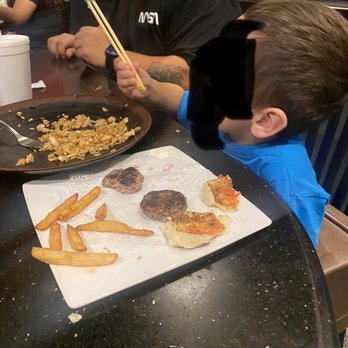 Samurai Japanese Steak - Kid enjoying the burger and rice. Half eaten which is a good sign. - Japanese Near Me - Webster, Texas