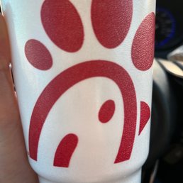 ows a hand holding a cup with a paw print ows a hand holding a cup with a paw print