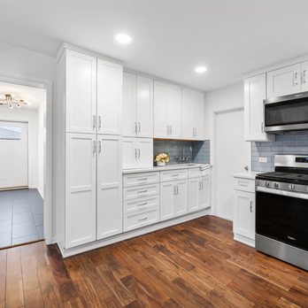 4Ever Remodeling - a kitchen with white cabinets and stainless steel appliances - General Contractors Near Me - Niles, Illinois