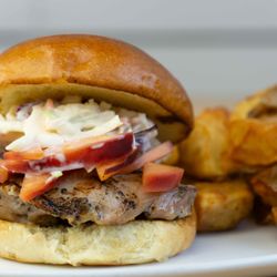 Taste Community Restaurant - Chicken Sandwich.
Sweet tea-infused grilled chicken topped with pickled peaches, summer slaw, and Alabama white sauce on a toasted brioche.