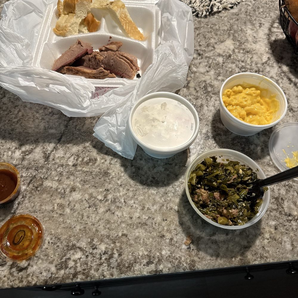 Brisket, collards, fake mac and cheese and brisket with a piece of bread.