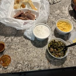 Brisket, collards, fake mac and cheese and brisket with a piece of bread. Brisket, collards, fake mac and cheese and brisket with a piece of bread.