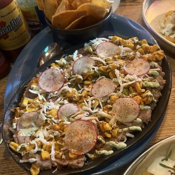 Magpie & Stump Restaurant - The Esquites- should have fully read that because it was light in the corn and then had guac and refried beans under that - Mexican Near Me - Banff, Alberta