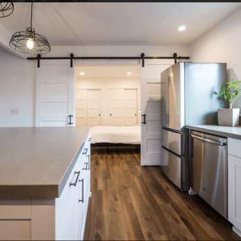Golden Star Construction - a kitchen with white cabinets and stainless steel appliances - General Contractors Near Me - Solana Beach, California