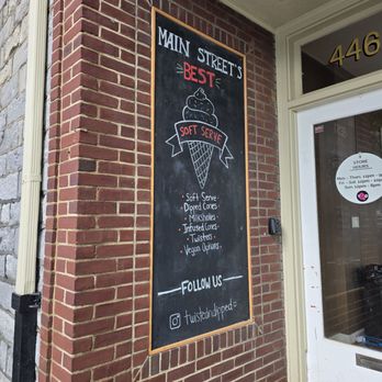 Twisted & Dipped - A chalkboard sign on a brick wall promotes soft serve ice cream with customizable options, including dipped cones and vegan choices. - Chocolatiers & Shops Near Me - Bethlehem, Pennsylvania