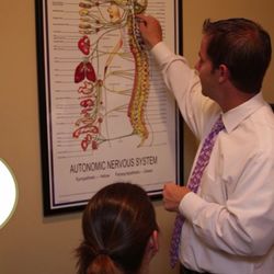 Upper Cervical Chiropractic of Georgia - Dr. Nick Tedder with a UCCGA patient in our Hamilton Mill office.
