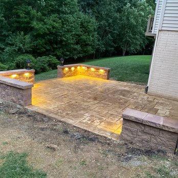 BMA Construction - 18 ft x 18 ft Patio with brown sand color stone template design on concrete and golden brown stone wall with led lights and lamp. - Drywall Installation & Repair Near Me - Baltimore, Maryland