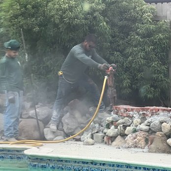 Greenscape - Tearing out the rock wall - Landscaping Near Me