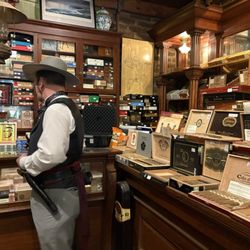 Racine & Laramie Tobacconist - Staff helping select in their humidor