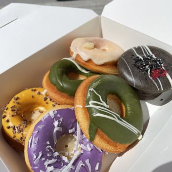 Third Culture Bakery - Berkeley - (From top left) Mango Passionfruit, Matcha, Yuzu Lemon, Ube Coconut, Matcha Butter Mochi Donuts, Black Sesame Mochi Donut - Bakeries Near Me - Berkeley, California
