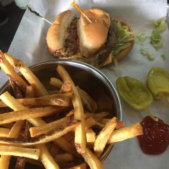 Corner Taproom - a hamburger and fries with ketchup - Sports Bars Near Me - Detroit, Michigan