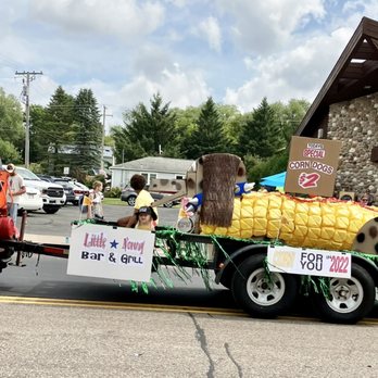Little Norway - a man driving a tractor with a corn cob on the back - Dive Bars Near Me - Scandinavia, Wisconsin Little Norway - a man driving a tractor with a corn cob on the back - Dive Bars Near Me - Scandinavia, Wisconsin
