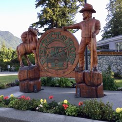District Hall - Carved-wood signage and statues - benches arranged at this location.