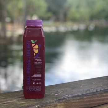 Full Press Juicery - a bottle of juice on a wooden table - Juice Bars & Smoothies Near Me - Orlando, Florida Full Press Juicery - a bottle of juice on a wooden table - Juice Bars & Smoothies Near Me - Orlando, Florida