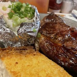 Steer'n Stein - Rib Eye Steak - Medium Rare. Comes with Garlic Bread, Salad & Baked Potato.
