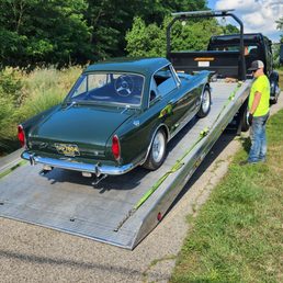 Our classic 1967 Sunbeam Tiger being loaded on Hansen's flatbed trailer.